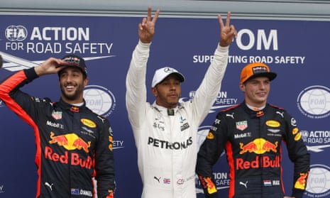 Mercedes’s Lewis Hamilton celebrates pole position between Daniel Ricciardo and Max Verstappen