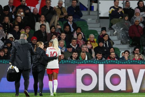 Ashley Lawrence is checked for a concussion at pitchside.