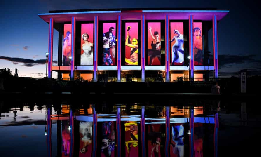 The National Library lit up brightly in the evening with projections and portraits