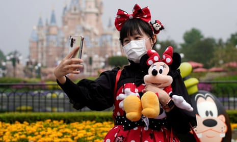 A visitor dressed in character takes a selfie at the Shanghai Disney Resort.