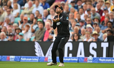 Devon Conway of New Zealand catches Sam Curran of England off the bowling of Trent Boult.