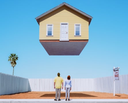 A couple looking up at a house floating above their reach.