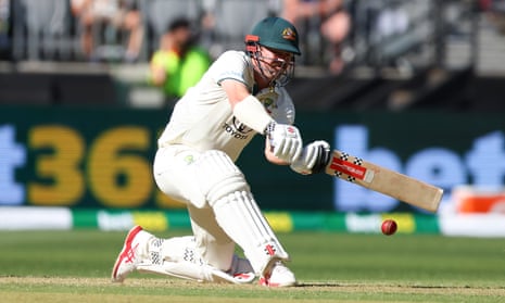 Travis Head sweeps for four as his partnership with David Warner gathers pace.