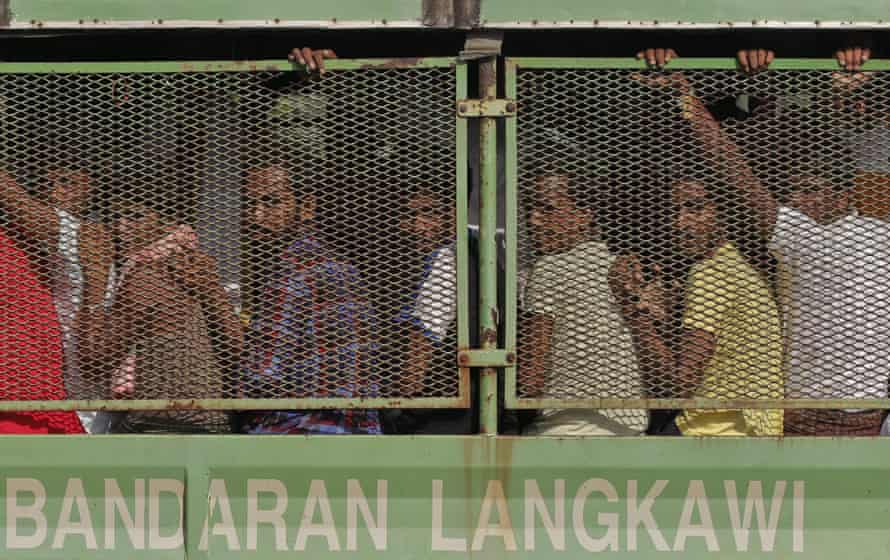 Bangladeshi and Rohingya migrants are seen in a truck as they arrive at a naval base before being transferred to Kuala Kedah jetty with the navy ship ‘KD Mahawangsa’, in Langkawi, Malaysia, 14 May 