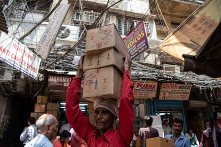 A man carries boxes of medicines to a shop in Bhagirath Palace’s pharmaceuticals market, Old Delhi, India.