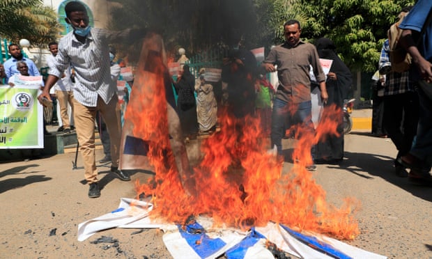 protesters with israeli flags on fire on the ground