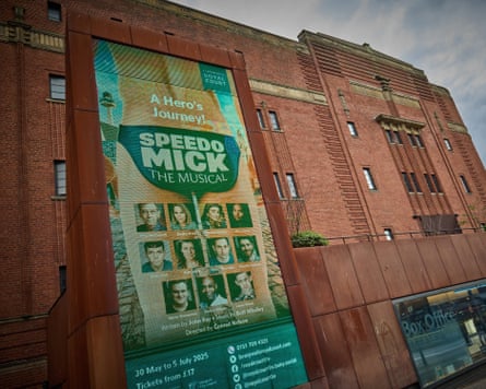 Red brick building with big banner promoting the musical on the front.