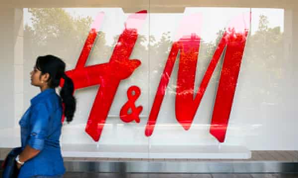 A passerby outside the first H&M to open in India, in New Delhi.