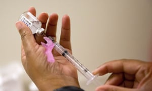 A nurse prepares a flu shot. 