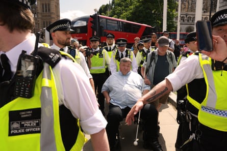 Mike Higgins, a blind disabled man, is arrested in Parlaiment Square.