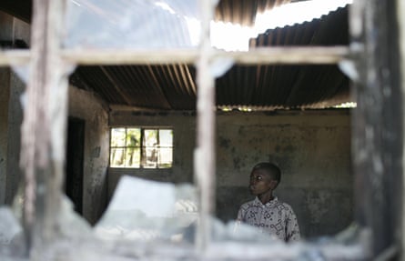 A boy inspects a house in the Kericho tea plantation compound which was burnt and looted during the unrest after the 2007 elections.