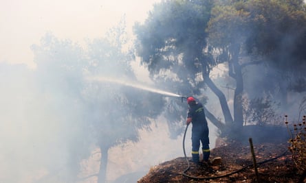 A firefighter tackling a wildfire in Greece