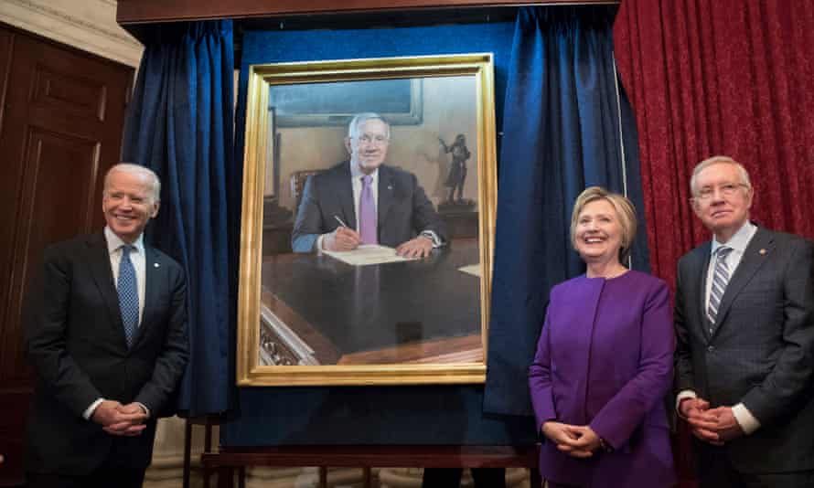 Hillary Clinton stands beside Harry Reid and Vice-President Joe Biden at the unveiling of a portrait of Reid.