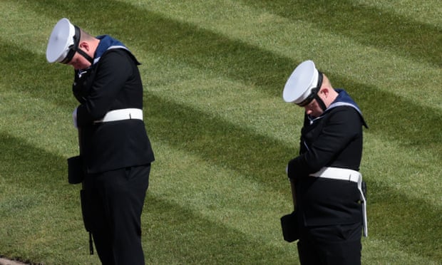 Members of the Royal Navy bow their heads outside St George’s Chapel