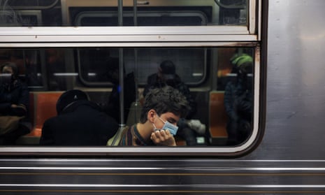A man wearing a protective face mask sleep on a subway train in New York City<br>A man wearing a protective face mask sleeps on a subway train in New York City, U.S., May 6, 2022. REUTERS/Shannon Stapleton