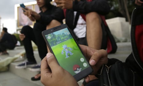 An Indonesian man shows his smartphone as he plays Pokémon Go in Jakarta, Indonesia. 