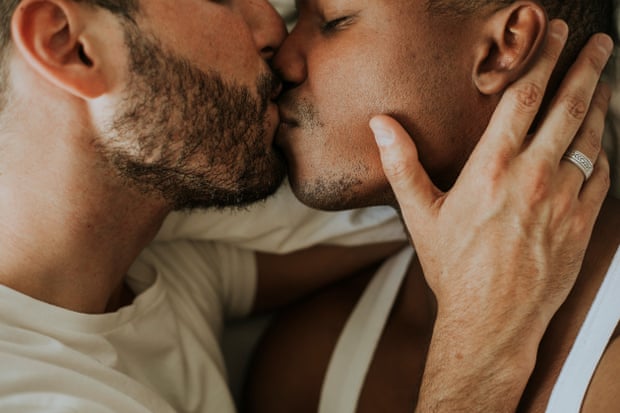 A close-up shot of a gay couple kissing