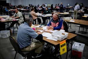 Electoral workers count votes into the night
