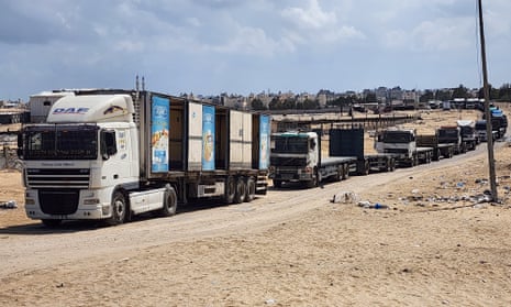 Trucks wait at the Rafah border gate to cross to the Egyptian side.