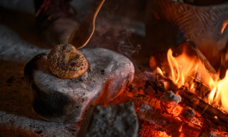 English Heritage volunteers bake mince pies around the hearth in Neolithic houses at Stonehenge