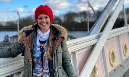 Amber Tallon wearing a red hat and stood on a bridge