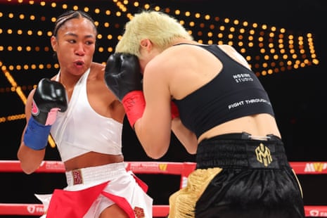 Alycia Baumgardner lands a left hand on Bo Mi Re Shin during their unified junior lightweight title fight early Saturday morning in New York.