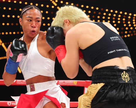 Alycia Baumgardner lands a left hand on Bo Mi Re Shin during their unified junior lightweight title fight early Saturday morning in New York.