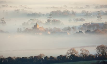 Firle and St Peter’s church emerges through mist.