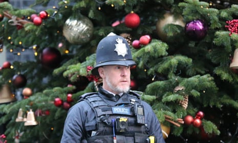 police officer in front of Christmas tree