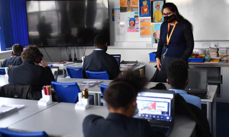 A teacher speaks to students in a classroom  in Birmingham in March 2021