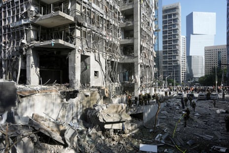 APTOPIX Israel Iran Mideast WarsRescue workers and military personnel inspect the site of a direct hit from an Iranian missile strike in Ramat Gan, Israel, Thursday, June 19, 2025. (AP Photo/Oded Balilty)