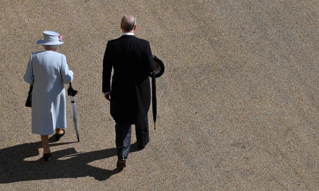 The Queen and Prince Andrew walking side by side with their backs to the camera