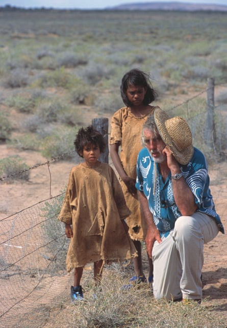 Philip Noyce with Everlyn Sampi and Tianna Sansbury next to the rabbit-proof fence