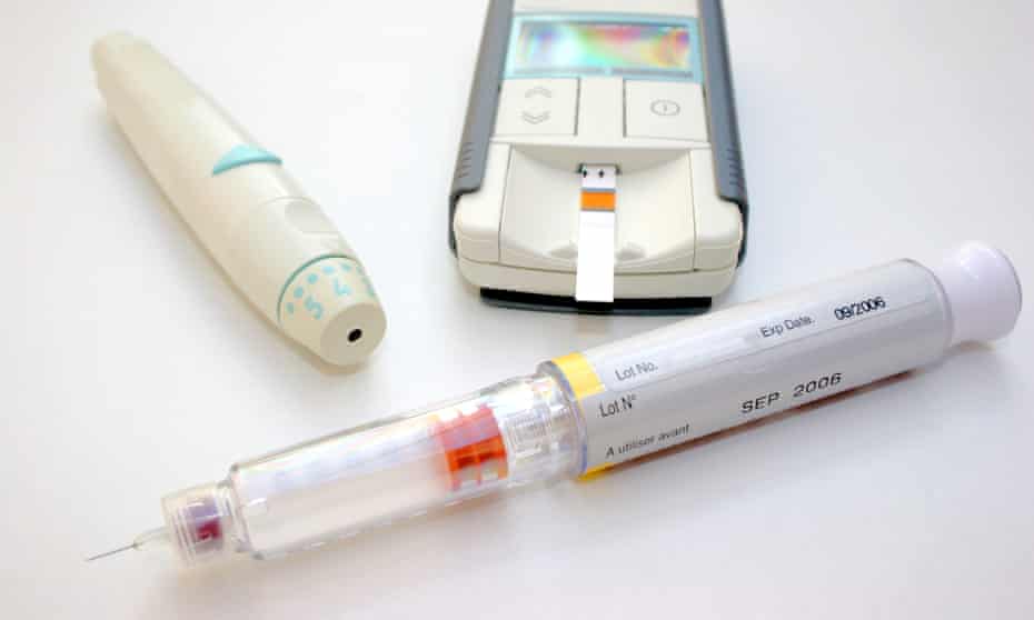 A shot of some items used to treat diabetes - syringe, blood tester