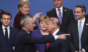 In this December 4, 2019, pic NATO Secretary General Jens Stoltenberg, center front left, speaks with Donald Trump after a group photo at a NATO leaders meeting at The Grove hotel and resort in Watford, Hertfordshire, England. From left, French President Emmanuel Macron, Norway’s Prime Minister Erna Solberg, German Chancellor Angela Merkel, Poland’s President Andrzej Duda and Greek Prime Minister Kyriakos Mitsotakis.