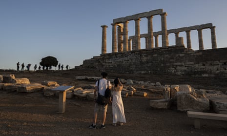 Tourists visit the ancient temple of Poseidon at Cape Sounion, about 45 miles south of Athens.