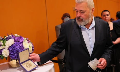 Dmitry Muratov, editor-in-chief of the Russian newspaper Novaya Gazeta, poses for photos with his 2021 Nobel Peace Prize