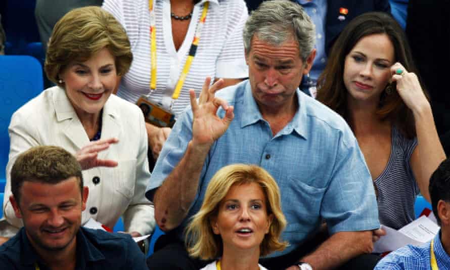 George and Laura Bush watch the swimming at the Beijing Games with their daughter Barbara