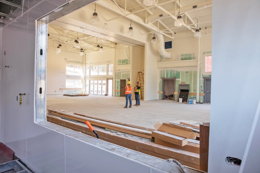 Maureen Frank and Taylor Gold stand inside what will be the main gathering space at the Groveland Resilience Center.