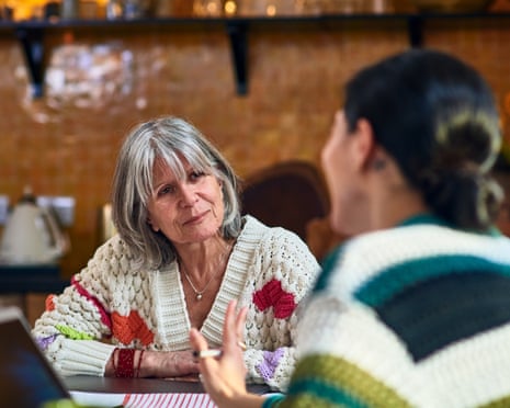 Senior woman mentoring young assistantWoman in her 60's working from home sitting at kitchen table listening to her assistant, working from home, monitorship, teamwork