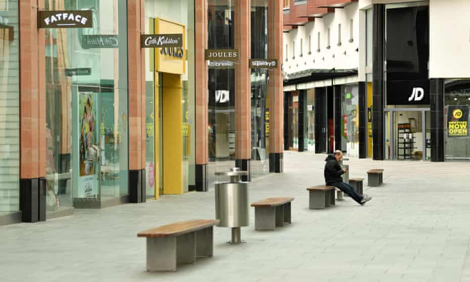 A lone member of the public sits in an empty Princesshay Shopping Centre in Exeter, England.