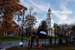 Television reporters report beyond the Glenn Memorial church ahead of a homage service for Carter on 27 November in Atlanta