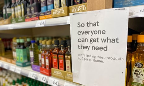 Cooking oil on shelves in a Tesco store in Ashford, Surrey with rationing sign