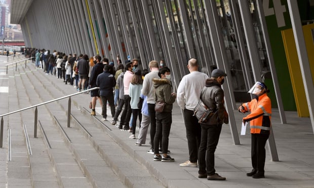 People form long queues outside a new vaccination centre at Melbourne town hall