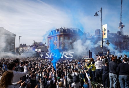 The Spurs team bus is greeted by fans with blue and white smoke as the team arrives at the stadium