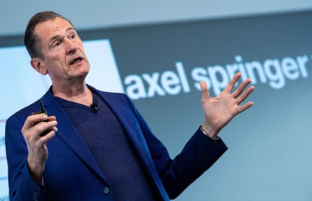 Axel Springer’s chief executive, Mathias Döpfner, gesturing with his hands in front of a sign reading ‘axel springer’