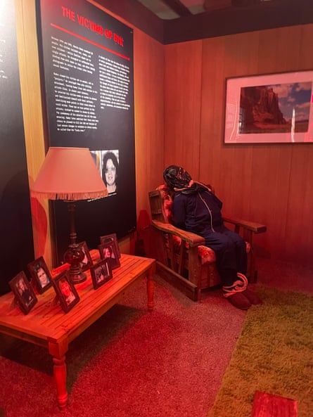 A child-size doll is bound and tied in a chair of a exhibit recreation of the BTK killer’s living room
