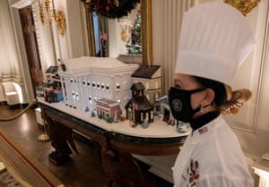 Susan Morrison, White House pastry chef, looks on near a gingerbread White House in the State Dining room