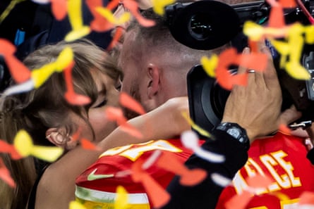 Travis Kelce kisses Taylor Swift as they celebrate after the Kansas City Chiefs Super Bowl win in 2024.