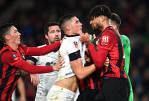 Philip Billing of Bournemouth clashes with Lloyd Jones of Luton Town. The Premier League side won the match 4-0.
